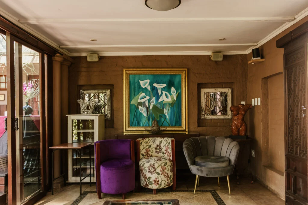 Lounge with colorful chairs and artwork at Casa Kaya.