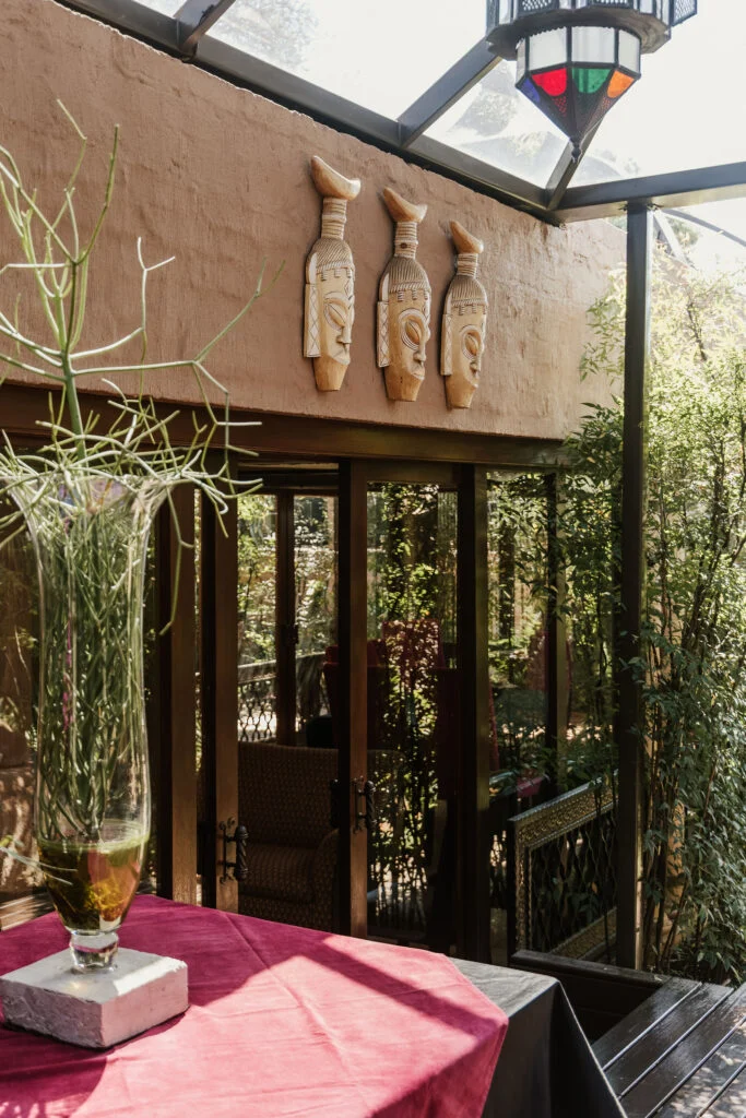 Carved wall masks above the garden seating area at Casa Kaya.