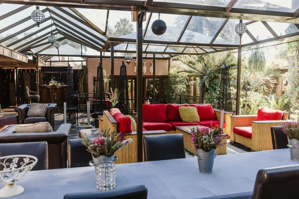 Lounge seating beneath the glass-roofed conservatory at Casa Kaya.